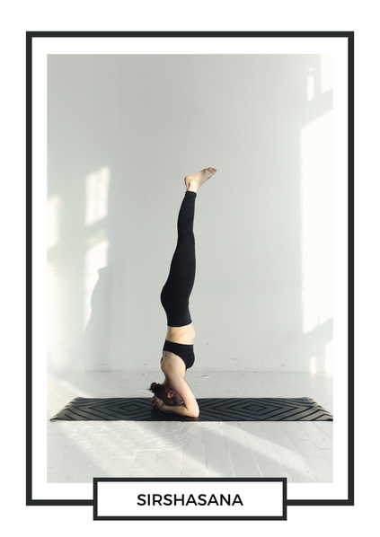 women in head stand pose yoga